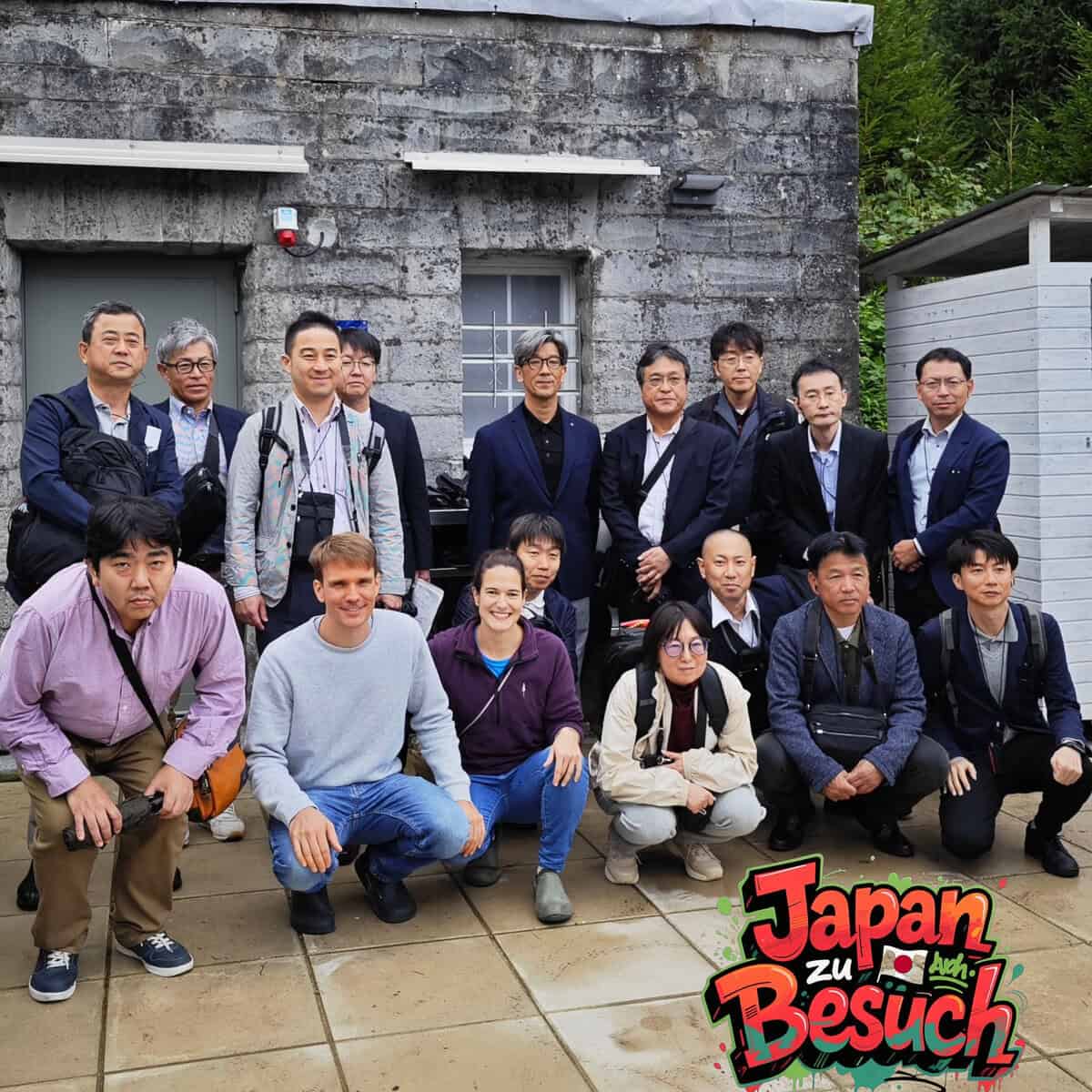 Japanisches Team posiert vor der Züripilz Pilzzuchtanlage für ein Gruppenfoto